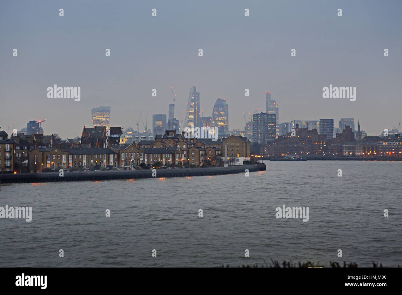 The River Thames looking south to Rotherhithe with City skyline beyond. Photographed at dusk in winter Stock Photo