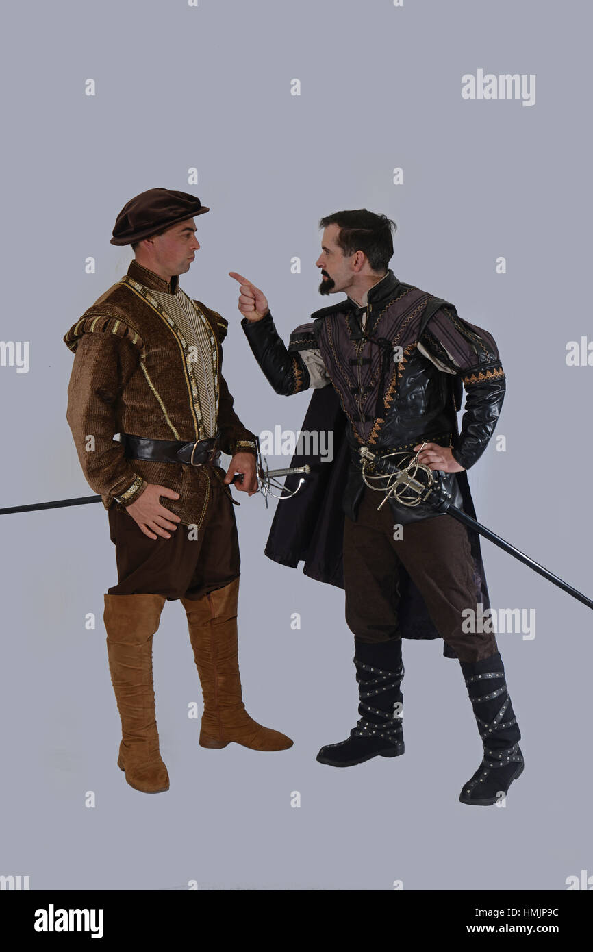 Actors in period costume argue against a grey background Stock Photo