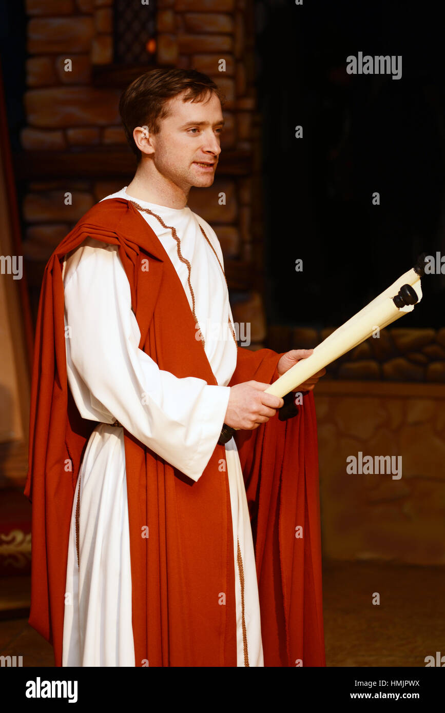 A character dressed in Roman costume reads from a scroll Stock Photo