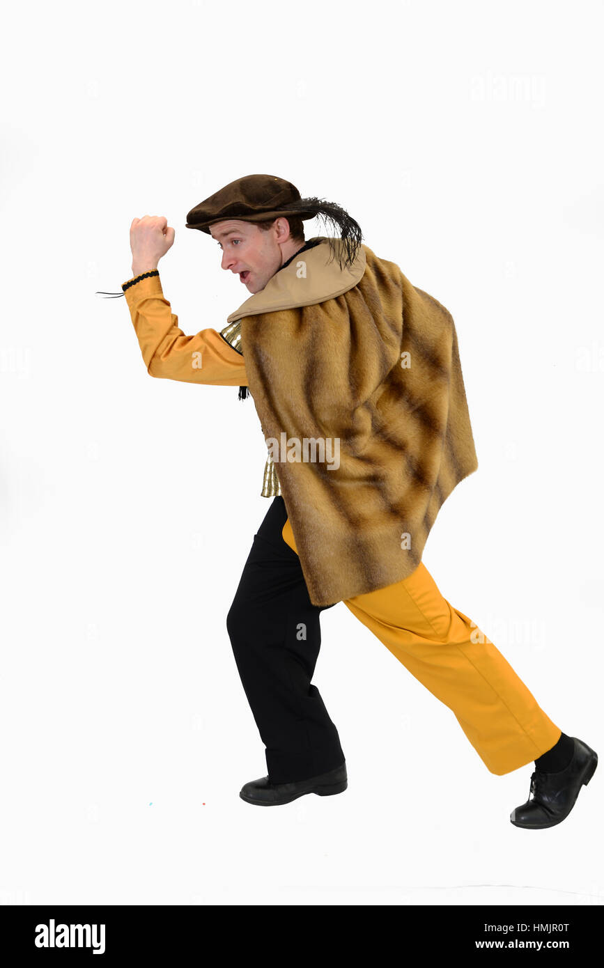 An actor in a court jester's costume poses in front of white background Stock Photo