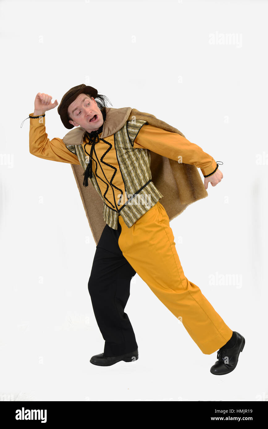 An actor in a court jester's costume poses against a white background Stock Photo