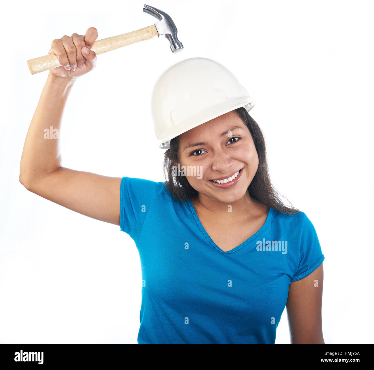 young hispanic girl with hammer hit her head isolated on white Stock Photo