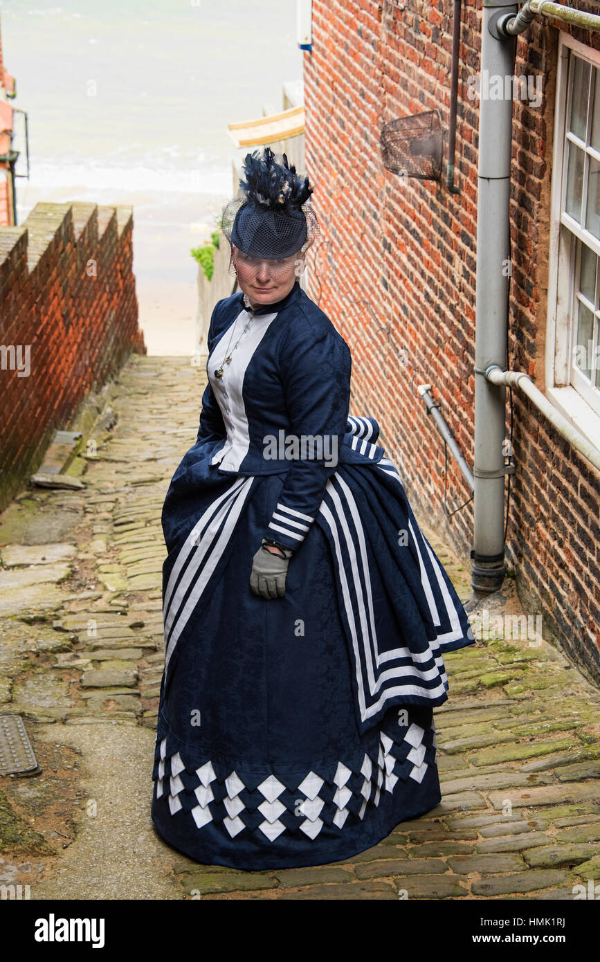 Goth woman posing on cobbled street at Goth weekend in Whitby Yorkshire. Stock Photo