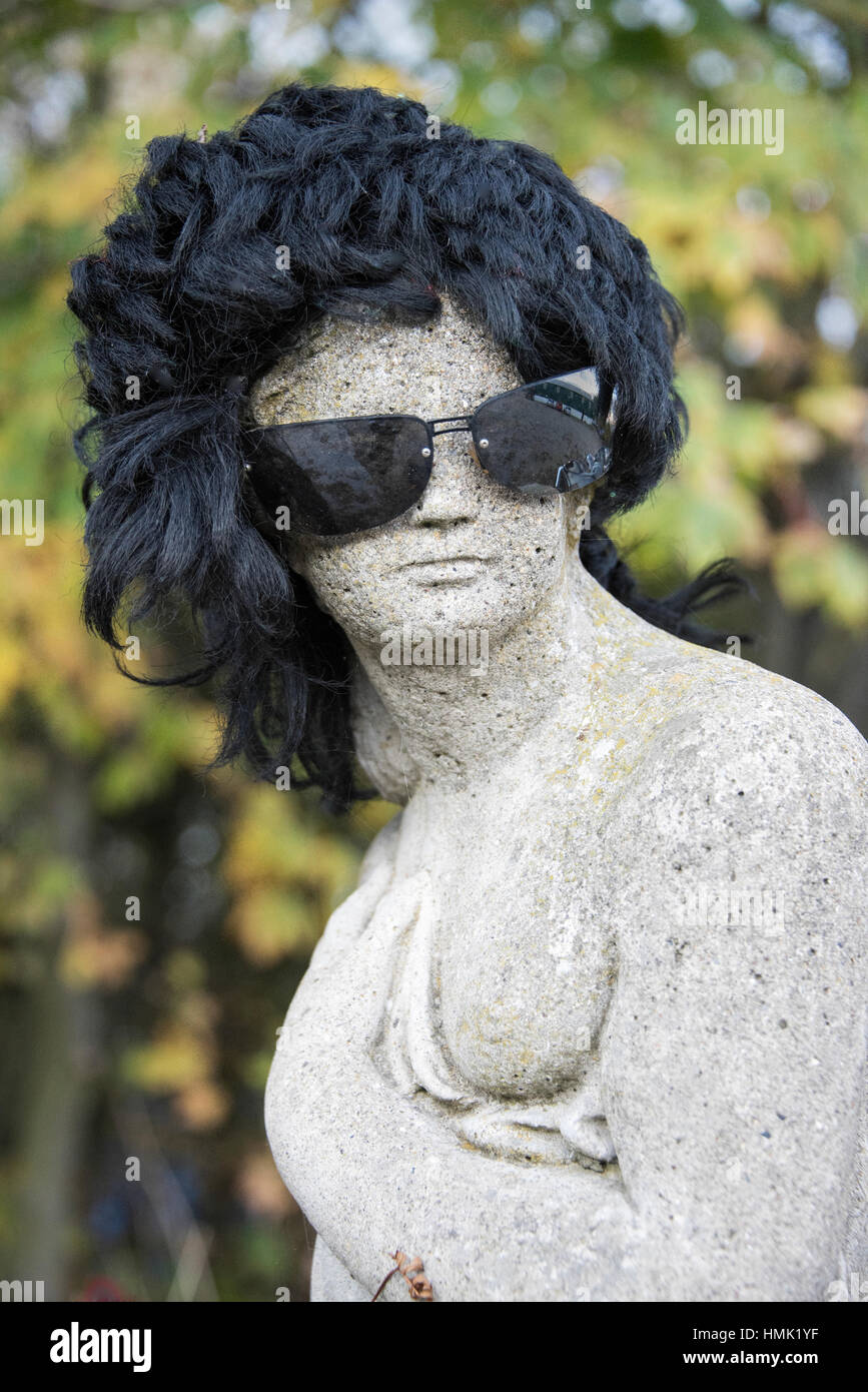 Fun shot of statue wearing wig and sunglasses. Stock Photo