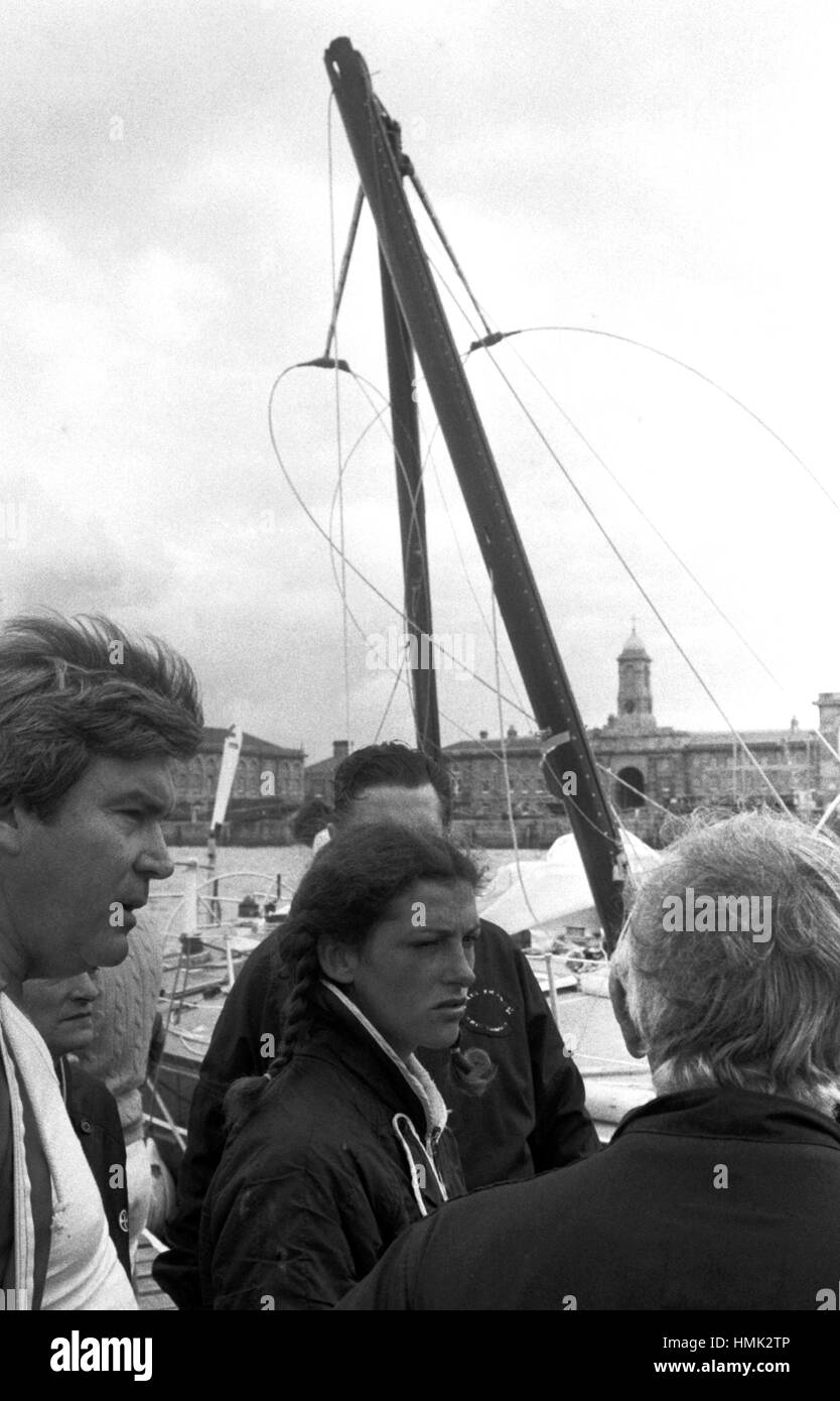 AJAXNETPHOTO. 7TH JUNE, 1980. PLYMOUTH, ENGLAND - OSTAR 1980 - FRENCH FAVOURITE OUT - FLORENCE ARTHAUD, SKIPPER OF 52FT SLOOP MISS DUBONNET (FRA) IS COMFORTED BY DUBONNET TEAM SUPPORTERS AFTER HER YACHT'S MAST SNAPPED IN HALF SHORTLY BEFORE THE START OF THE RACE FORCING HER TO RETIRE.   PHOTO : JONATHAN EASTLAND/AJAX  REF:800706 12 Stock Photo