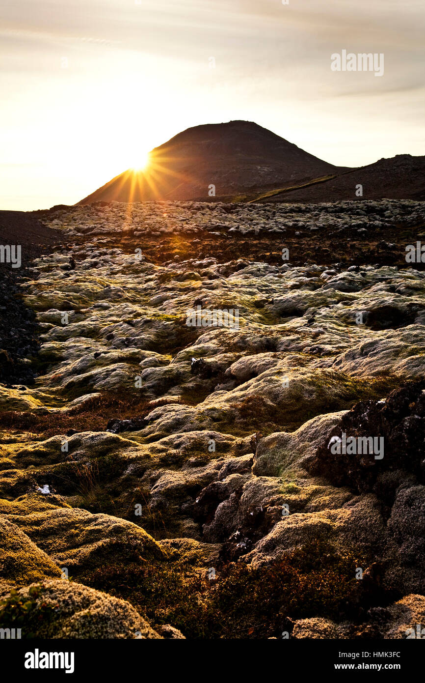 Backlit lava field with volcano crater, Eldvarpahraun, Reykjanes, Iceland Stock Photo
