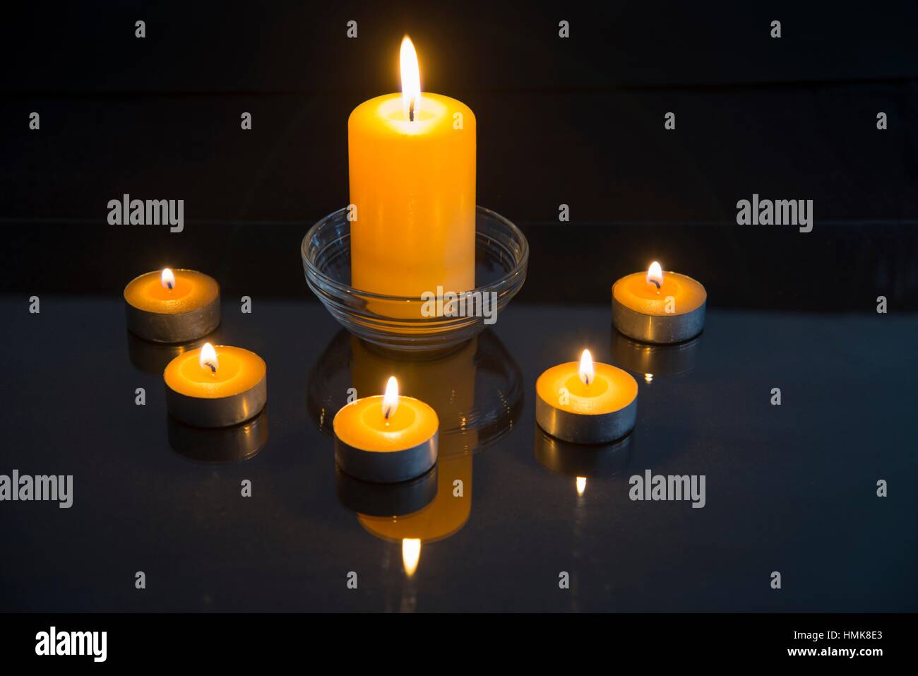 Lit up candles and their reflection on glass Stock Photo Alamy