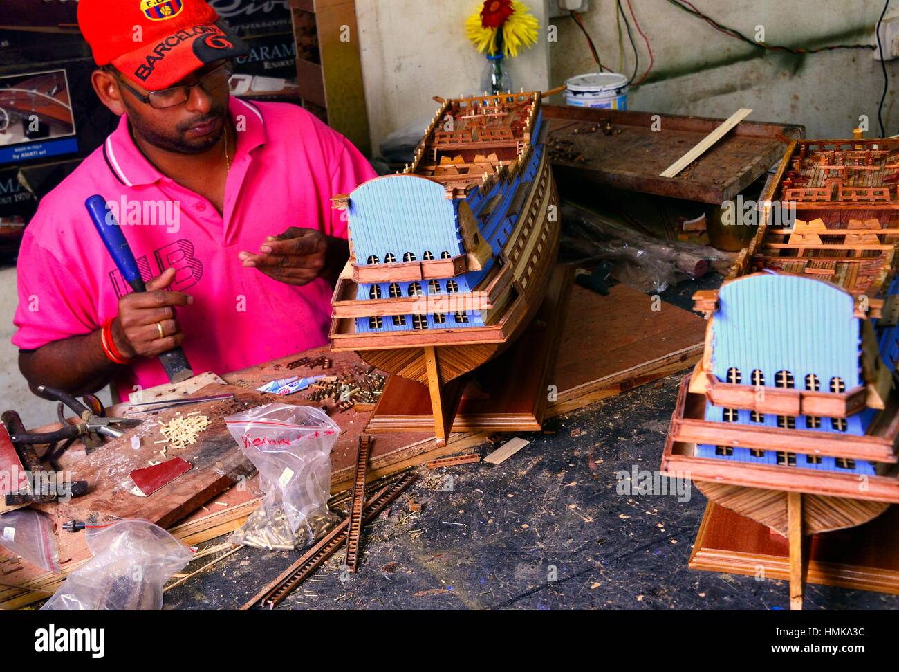 man working in factory of handmade scale model wooden ships in Curepipe, Mauritius, Africa Stock