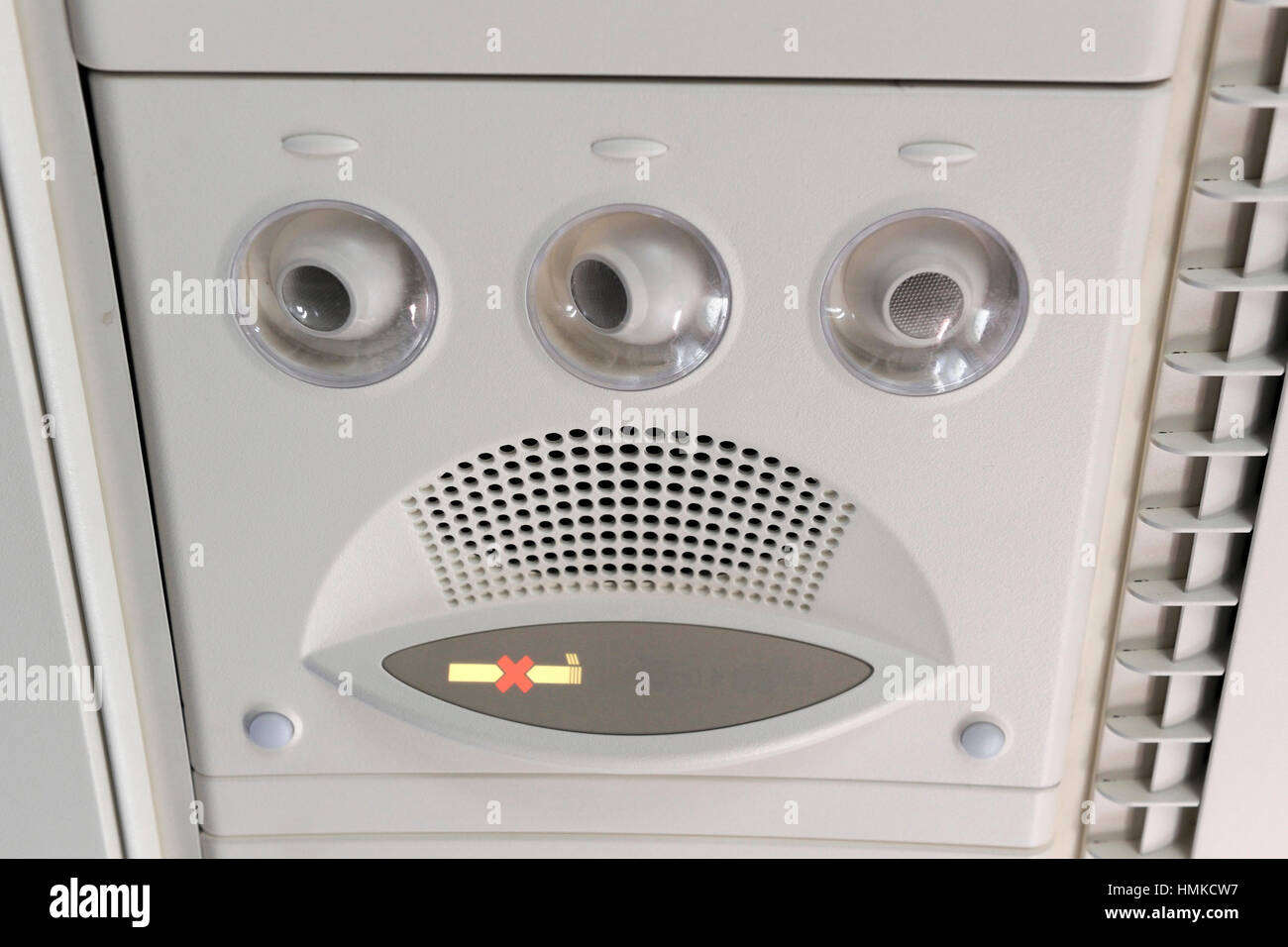 overhead fresh-air vents no smoking sign in economy-class cabin Singapore Airlines Airbus A380 enroute flight-number SQ317 Stock Photo