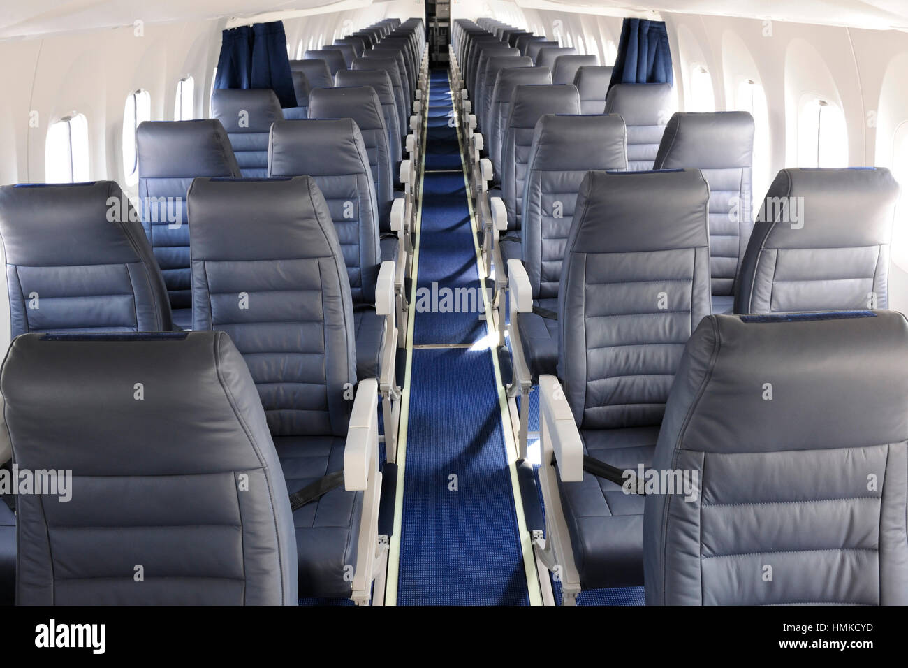 aisle empty passenger cabin seats on AirBaltic Bombardier DHC-8 Q400 Next Generation parked in static-display at Stock Photo