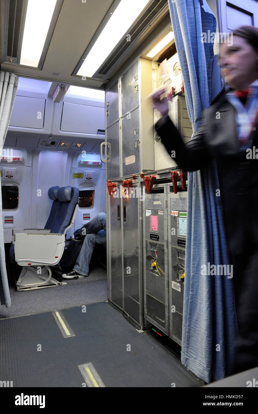 stewardess walking past galley in economy-class cabin seats Air Canada ...