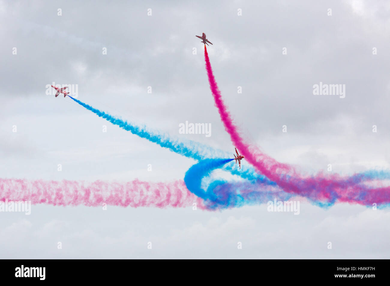 Bournemouth, Dorset, ENGLAND - August 21, 2016: Bournemouth Air Festival 2016 - Three Hawk T Red Arrow jets perform aerobatics and mid air stunts acro Stock Photo