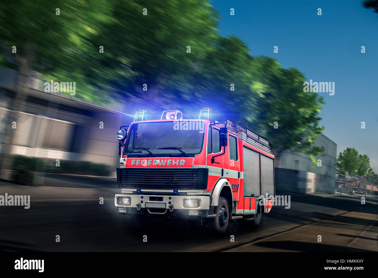 Fire truck driving with blue light Stock Photo - Alamy