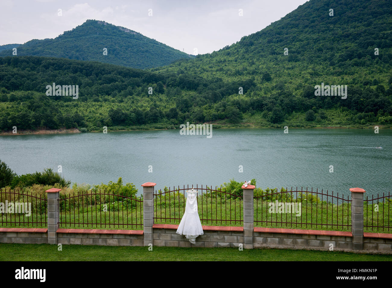 Wedding bridal dress is hanging outside. Lake view. Landscape Bulgaria Stock Photo