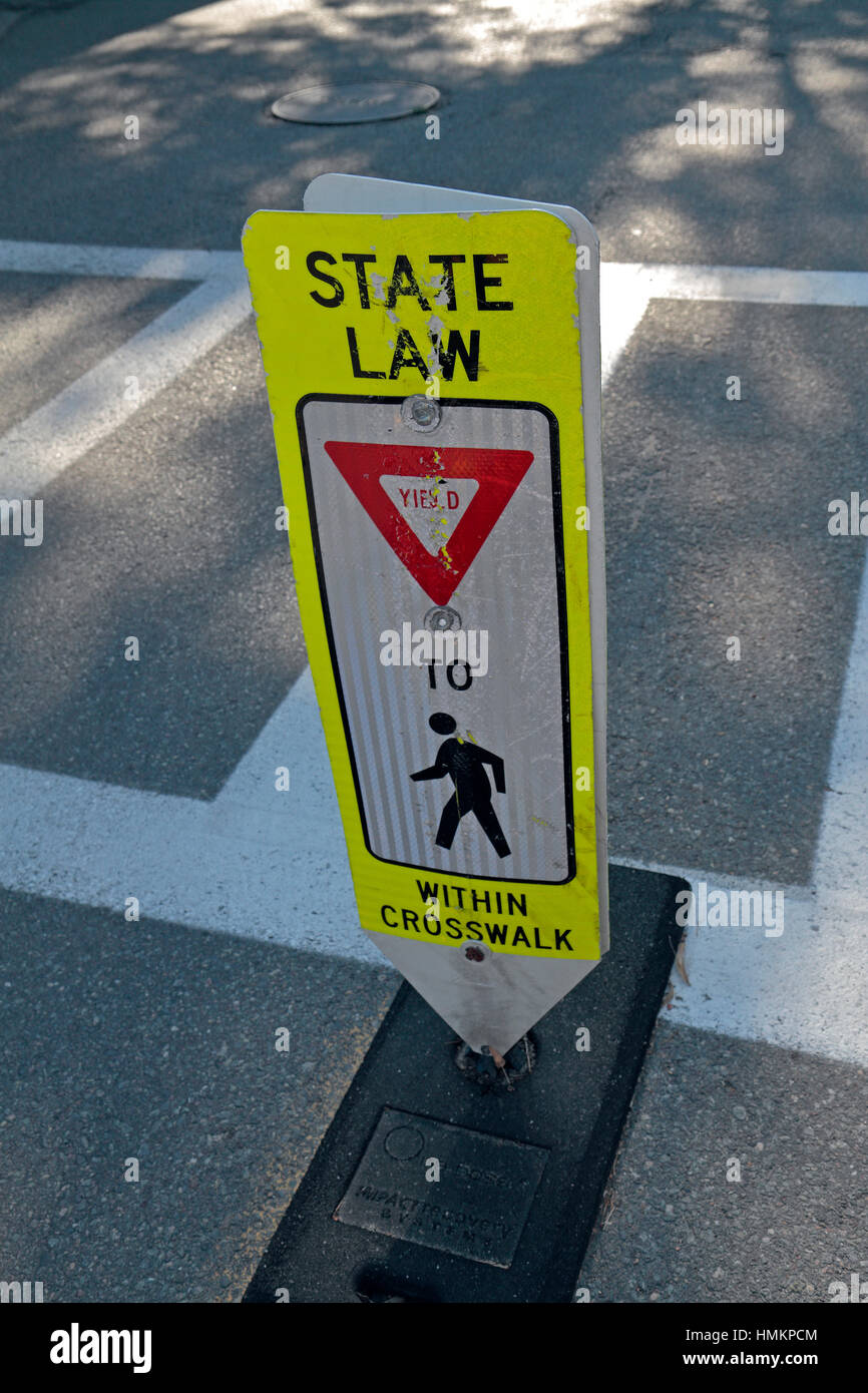 Crosswalk safety sign warning people to cross at crossings and not to