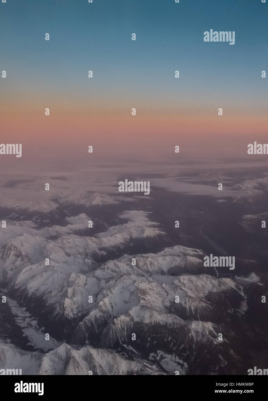 Aerial view of snowy mountains at sunset Stock Photo - Alamy
