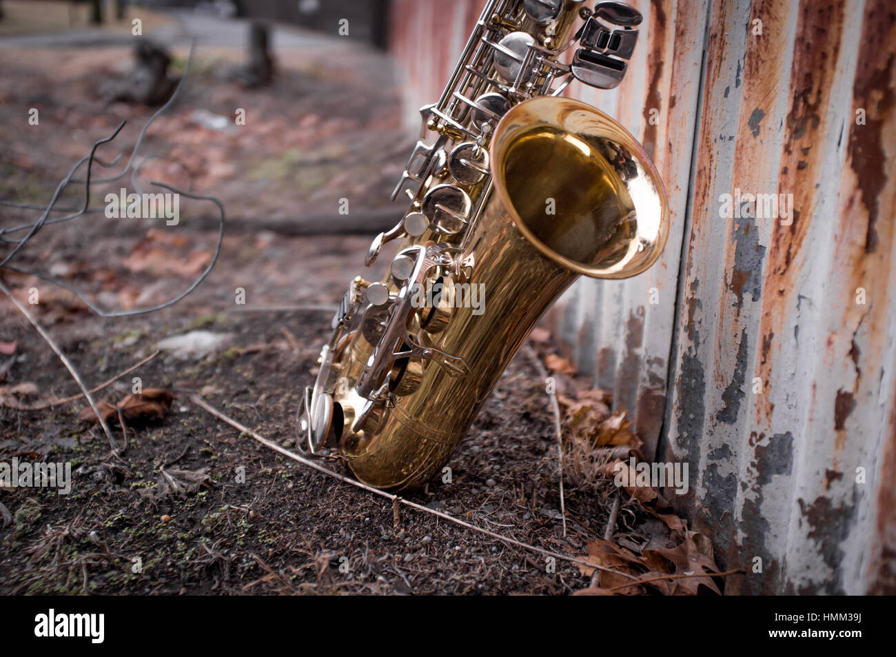 Jazz musical instrument saxophone with rusty fence background Stock
