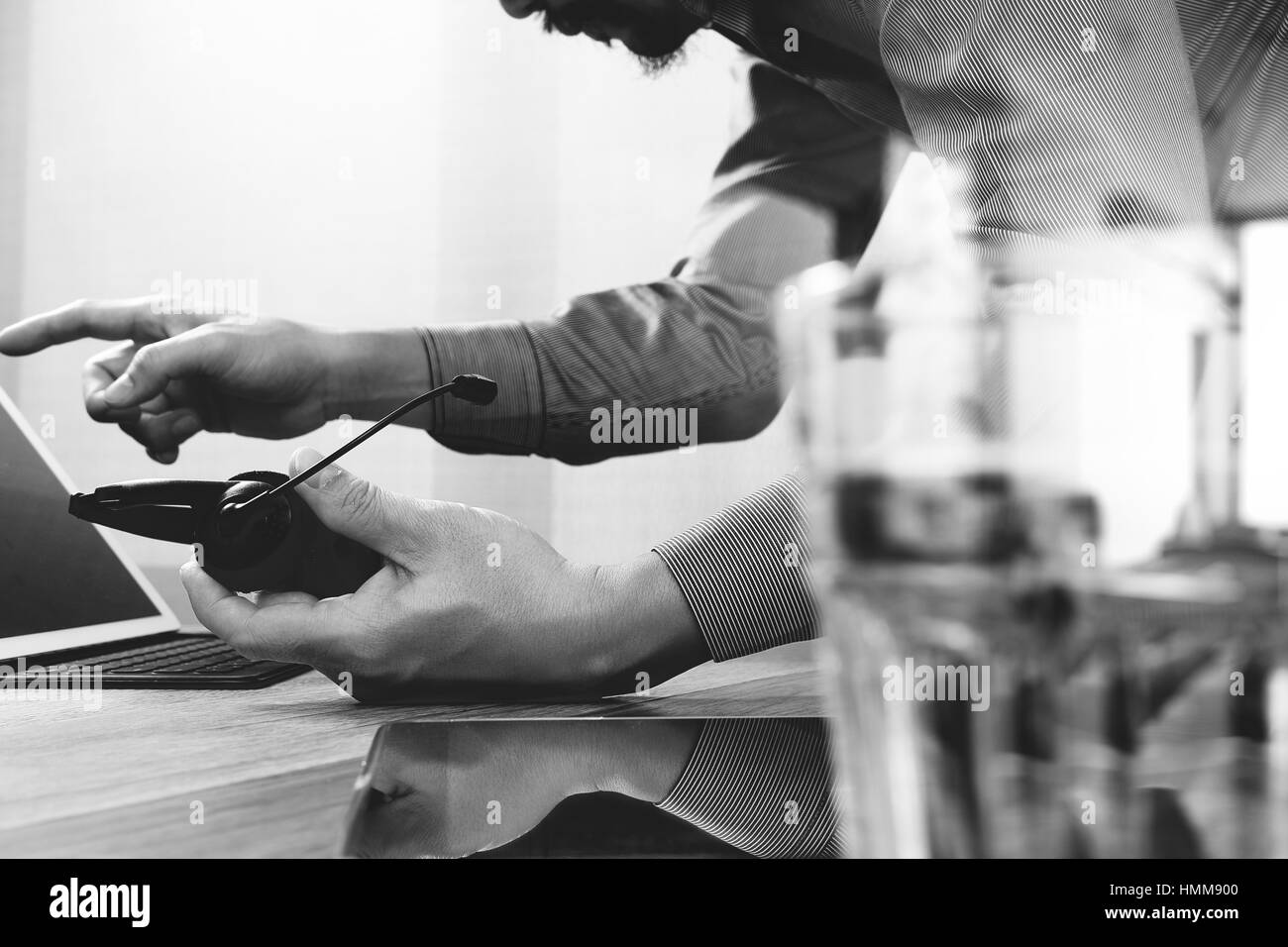 Man using VOIP headset with digital tablet computer docking smart keyboard, concept communication, it support, call center and customer service help d Stock Photo