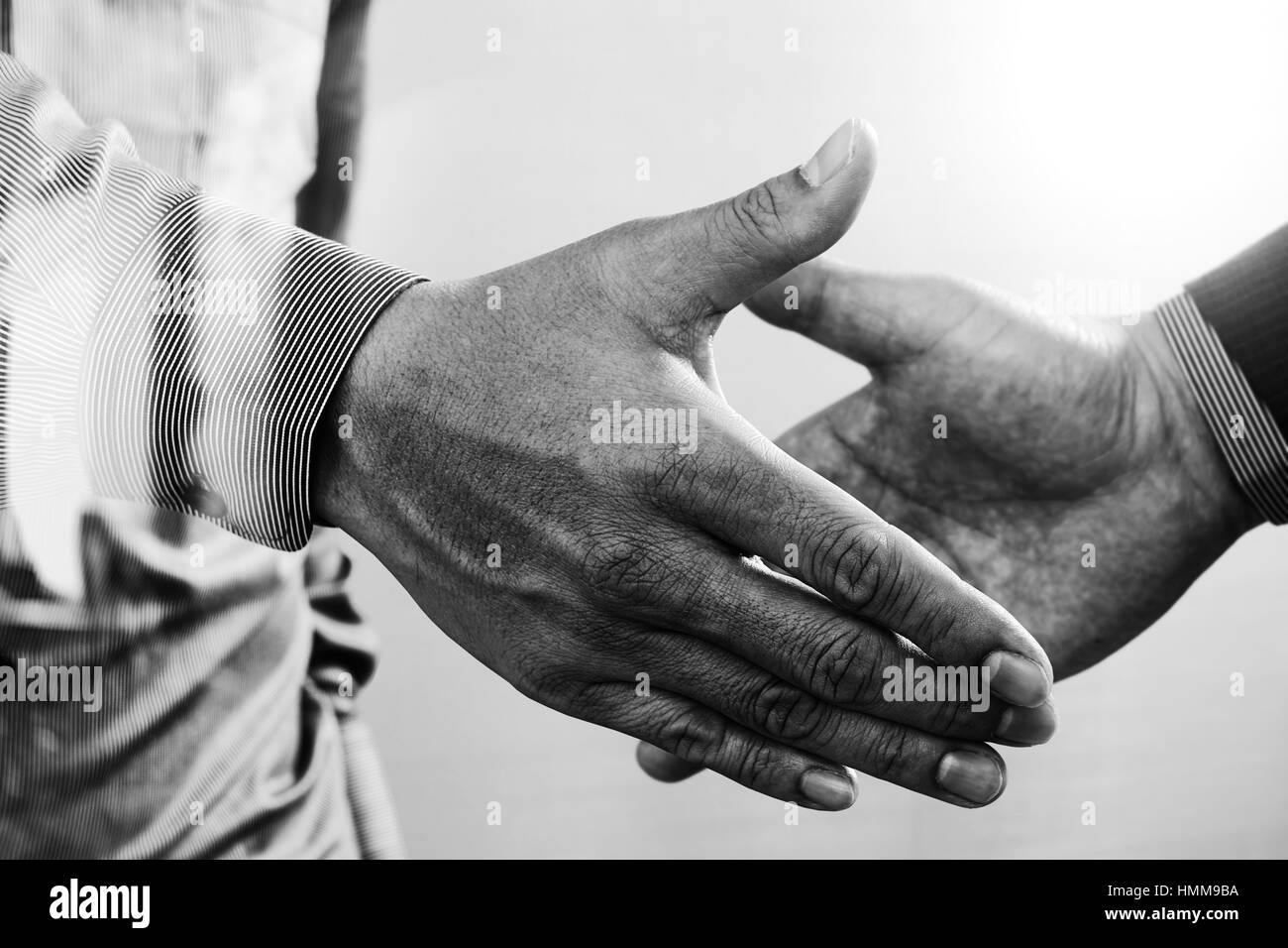 Business partnership meeting concept.photo businessmans handshake. Successful businessmen handshaking after perfect deal.close up,black and white Stock Photo