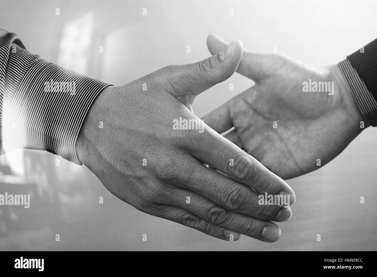 Business partnership meeting concept.photo businessmans handshake. Successful businessmen handshaking after perfect deal.close up,black and white Stock Photo