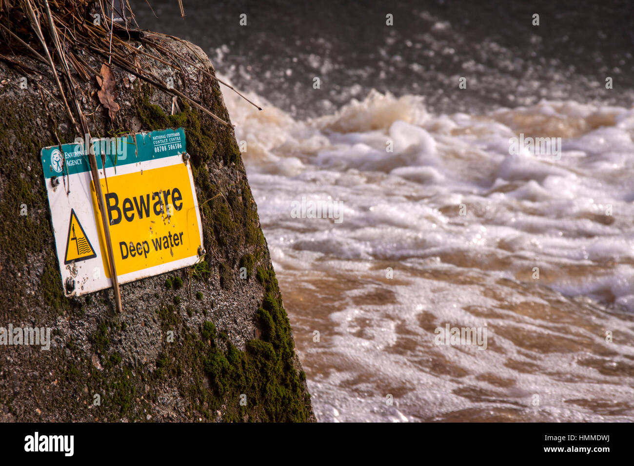 Danger, deep water sign at the weir on the River Otter, at Otterton Devon, part of the 'Beaver Trail'. Stock Photo