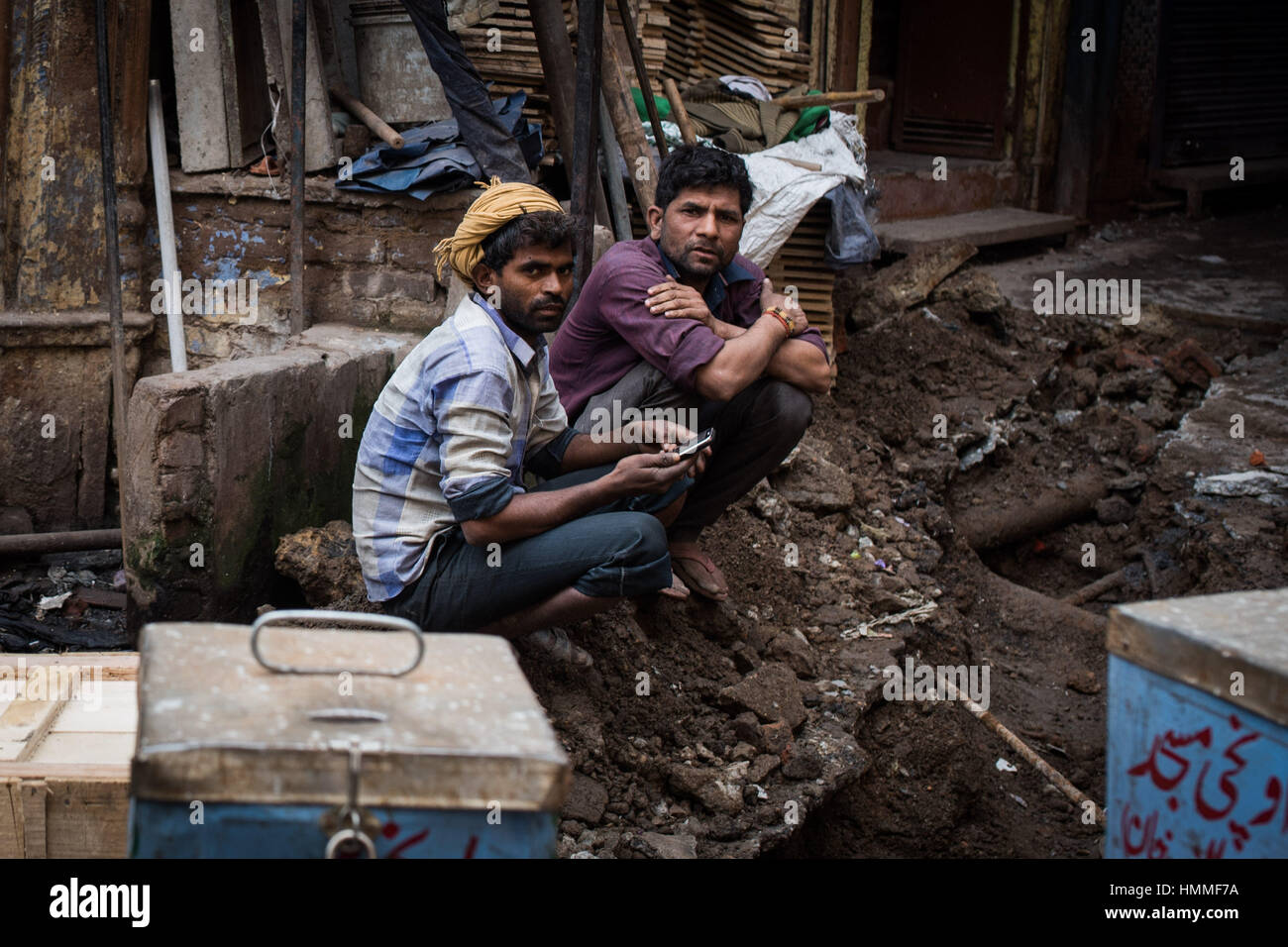 Indian workmen having a break from digging up the road in Old Delhi Stock Photo