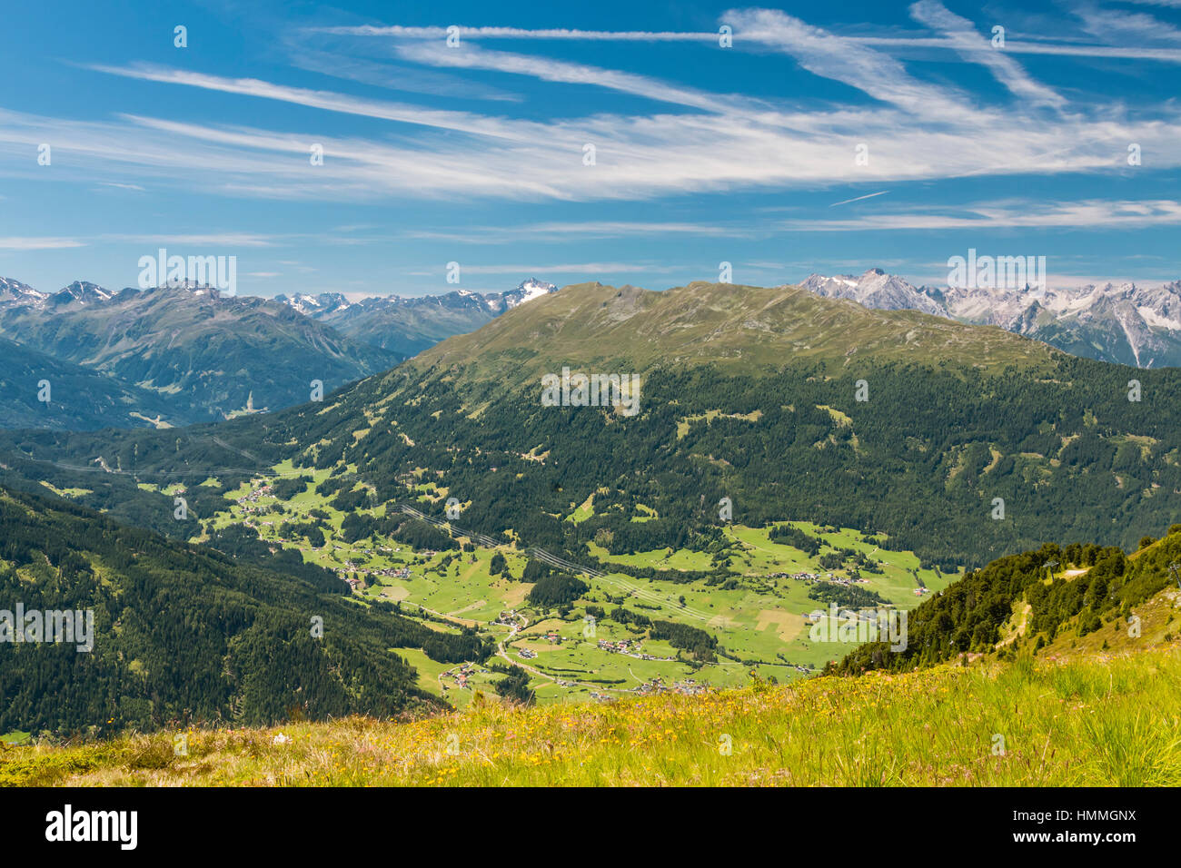 Summer view to the villages Wenns and Jerzens in the Pitztal, Austria with a flower meadow in the foreground Stock Photo
