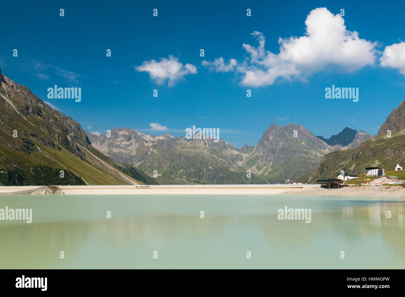 The Silvretta Stausee Reservoir Lake in Summer, Austria with deep blue sky Stock Photo