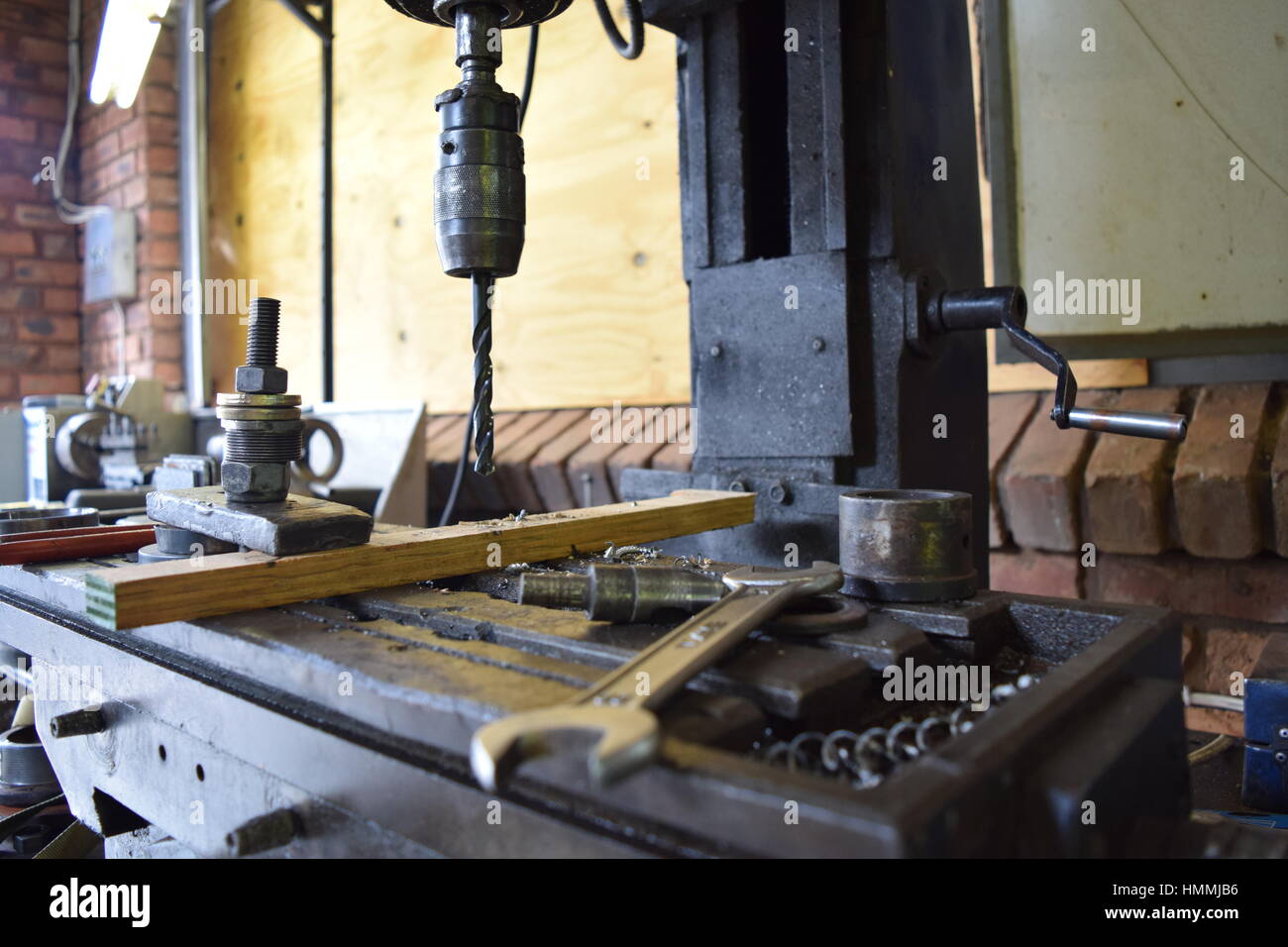 Engineering workbench with a drill machine and some tools and wrenches. Stock Photo