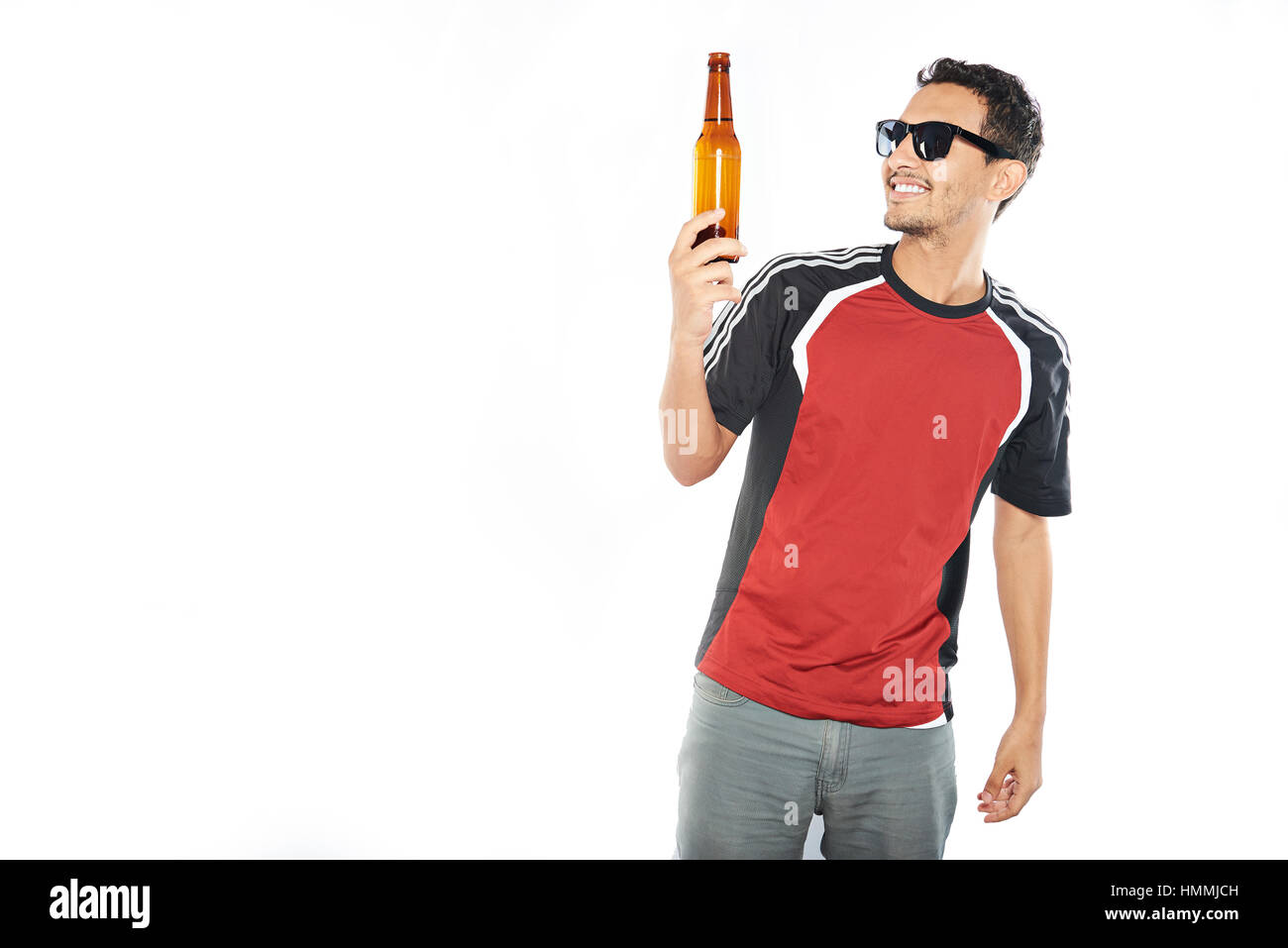 arab young man holding beer bottle isolated on white Stock Photo