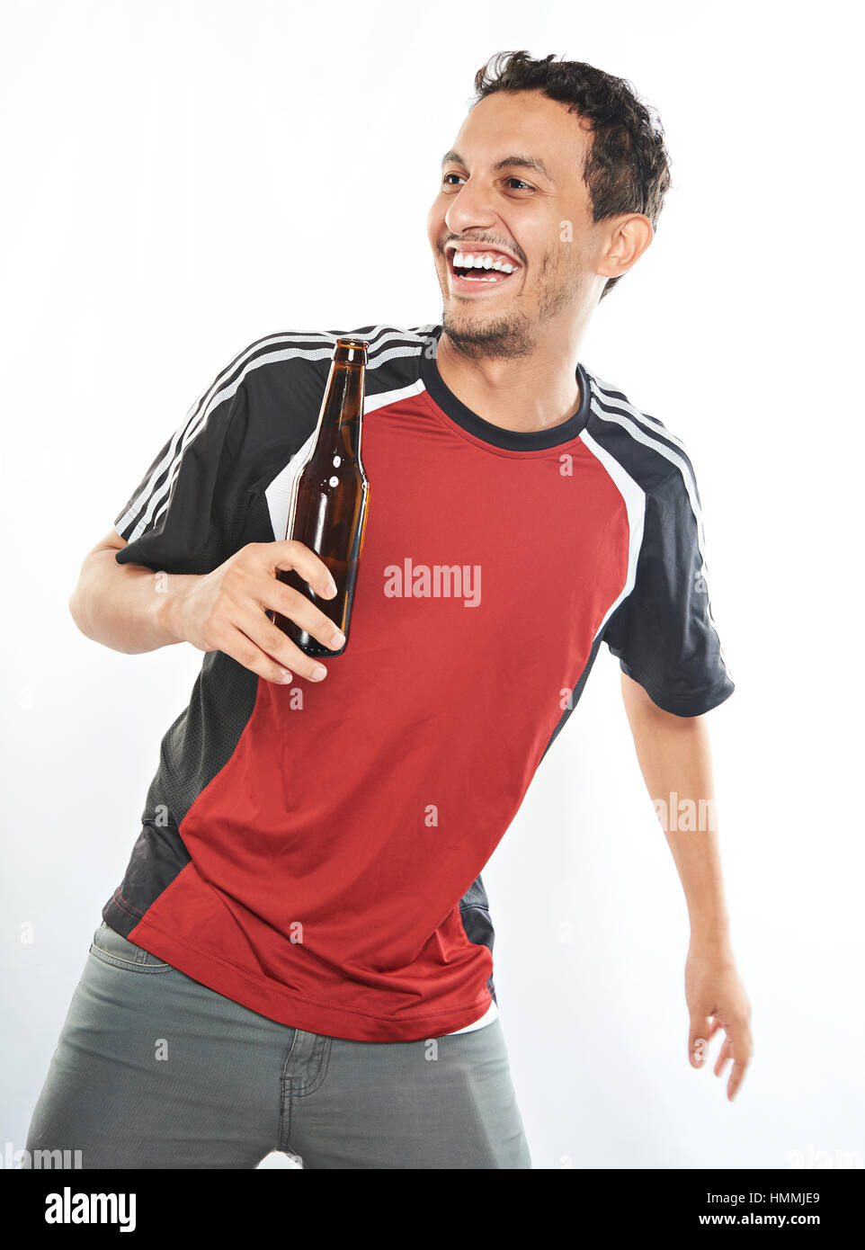 young arab man with beer bottle having fun isolated on white Stock Photo