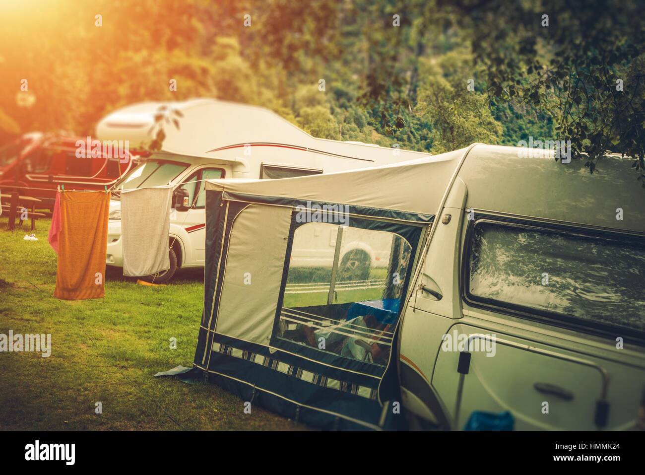 Summer RV Camper Camping. Relaxing on the Campground. Stock Photo
