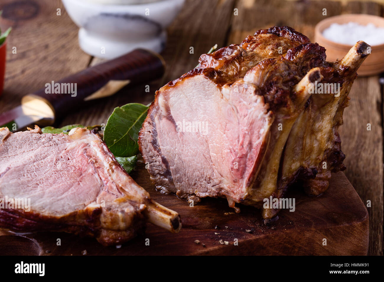 Homemade bone-in prime rib roast on rustic wooden table Stock Photo