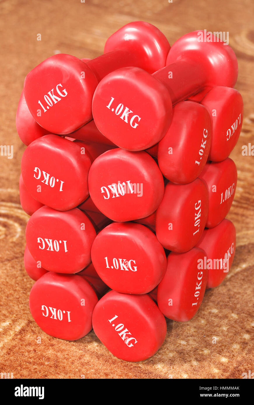 Kilogram Red Many red dumbbells weighing one kilogram on the carpet Stock Photo - Alamy