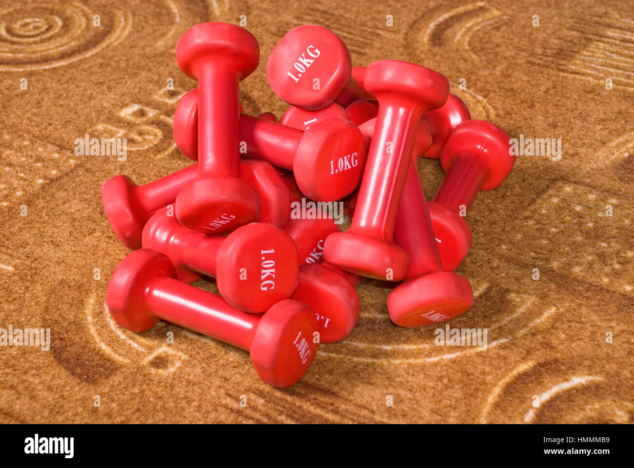 Kilogram Red Many red dumbbells weighing one kilogram on the carpet Stock Photo - Alamy