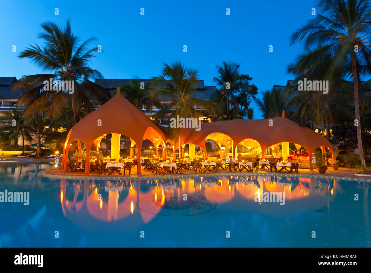Diani Beach, Kenya - February 17: Restaurant and illuminated pool landscape in the Southern Palms Beach Resort at night on February 17, 2013 Stock Photo