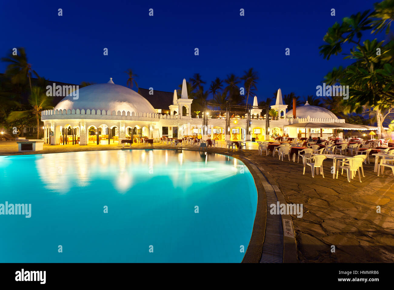 Diani Beach, Kenya - February 17: Restaurant and illuminated pool landscape in the Southern Palms Beach Resort at night on February 17, 2013 Stock Photo