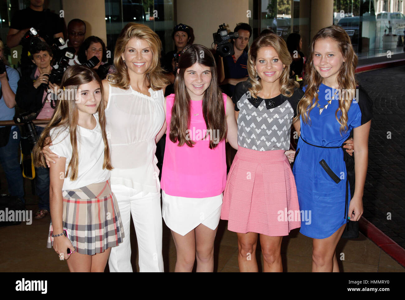 From left, Olivia Jade Giannulli, her mother, Lori Loughlin, Isabella Rose Giannulli, with Candace Cameron Bure and her daughter, Natasha Valerievna Bure arrive for the Hallmark Channel and Hallmark Movie Channel presentation at the 2013 Summer TV Critics Press Tour on July 24, 2013 in Beverly Hills, California. Photo by Francis Specker Stock Photo