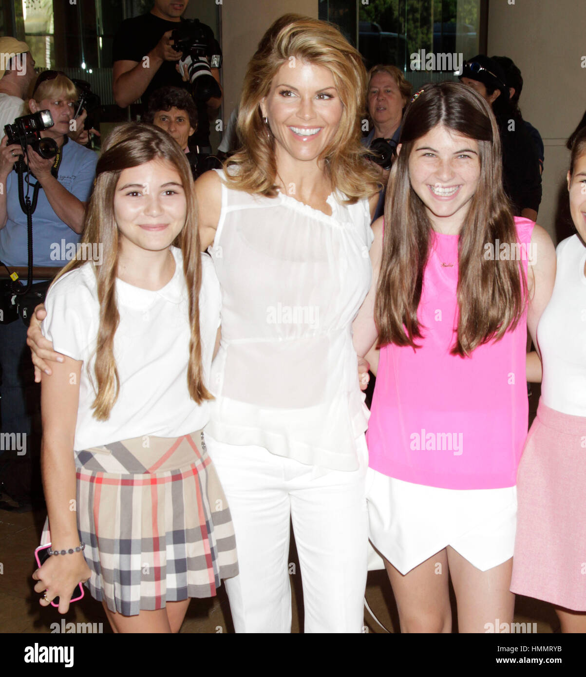 Lori Loughlin, center, with her daughters, Olivia Jade Giannulli, left, and Isabella  Rose Giannulli arrive for the Hallmark Channel and Hallmark Movie Channel  presentation at the 2013 Summer TV Critics Press Tour