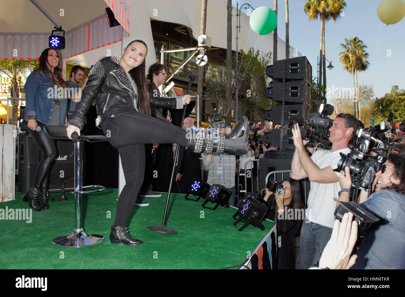 Demi Lovato kicks up her broken leg while performing  for the the grand opening of Topshop Topman at the Grove on February 14, 2013 in Los Angeles, California. Photo by Francis Specker Stock Photo