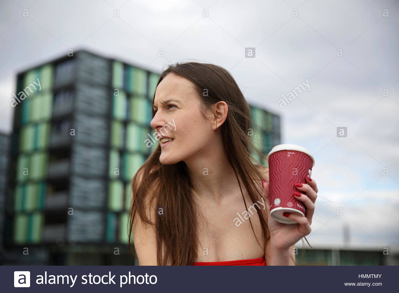 Woman drinking coffee in an urban environment Stock Photo