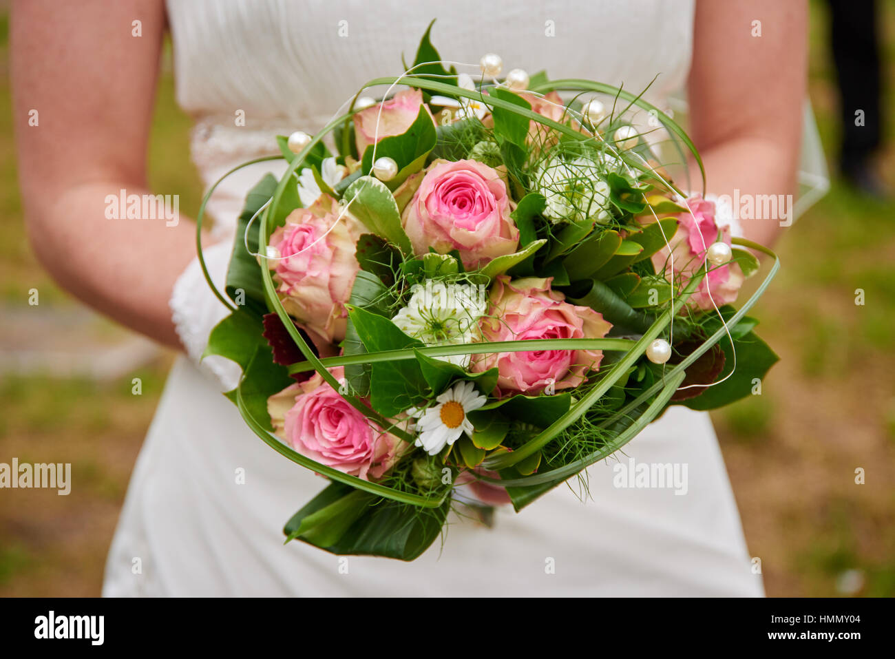 bride holding wedding bouquet pink roses Stock Photo - Alamy