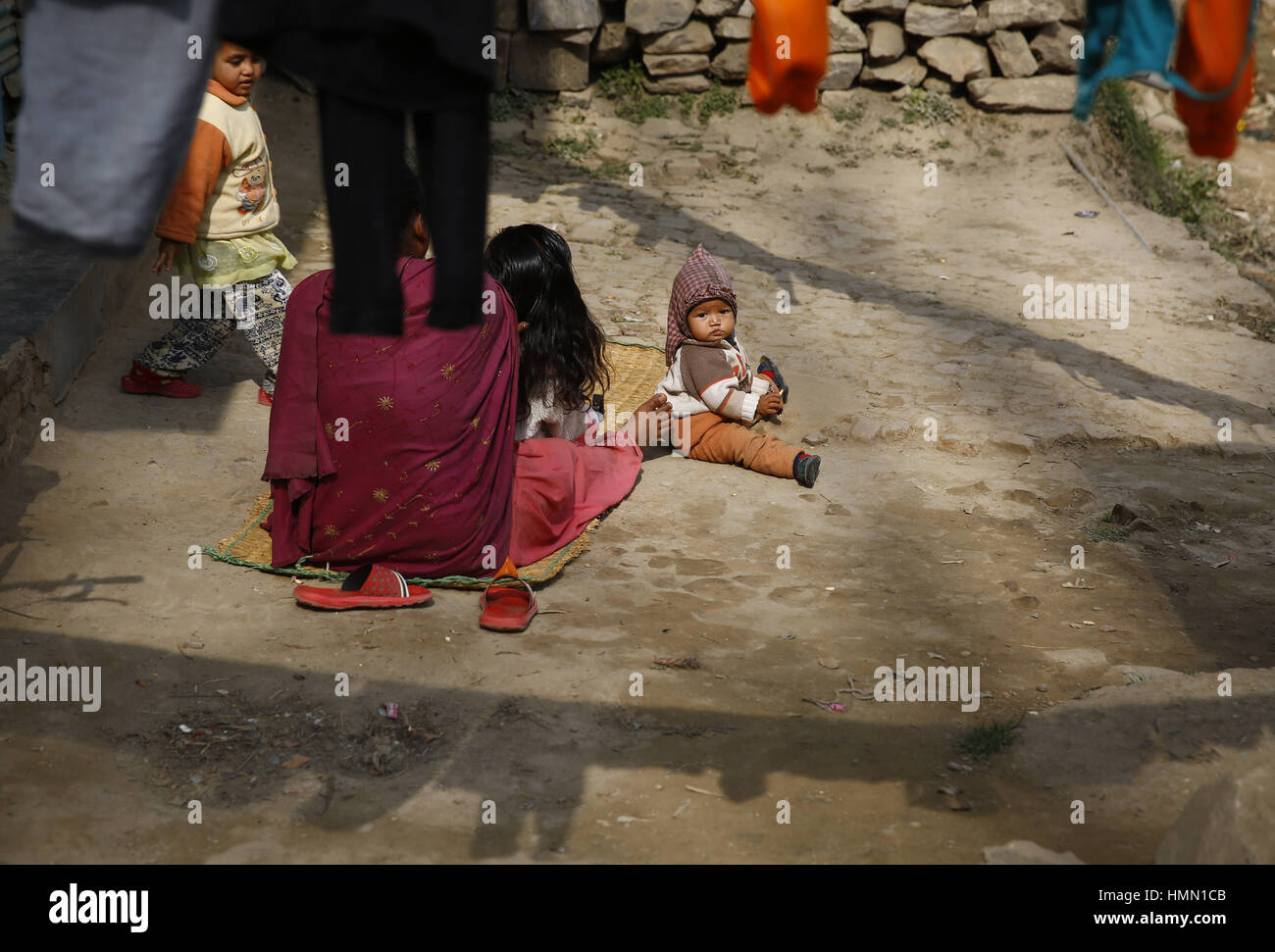 February 4, 2017 - Kirtipur, Nepal - A child looks on while sun basking during the winter season in the outskirts of Kathmandu in Nepal on Saturday, February 4, 2017. (Credit Image: © Skanda Gautam via ZUMA Wire) Stock Photo