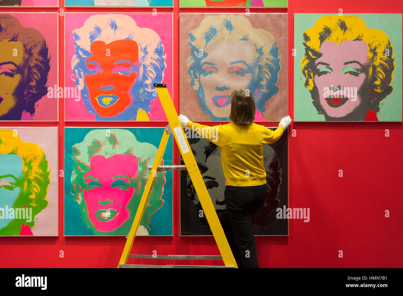 British Museum, London, UK. 10th February, 2017. 10 colour screenprints created 50 years ago by Andy Warhol have been installed in the British Museum’s Sainsbury Exhibitions Gallery ahead of the opening on 9th March of the Museum’s spring headline exhibition The American Dream: Pop to the present. Project curator Catherine Daunt makes final adjustments to the works positioning on the gallery walls. © 2016 The Andy Warhol Foundation for the Visual Arts, Inc./Artists Rights Society (ARS), New York and DACS, London. Tate, London 2016. Credit: Malcolm Park editorial/Alamy Live News Stock Photo
