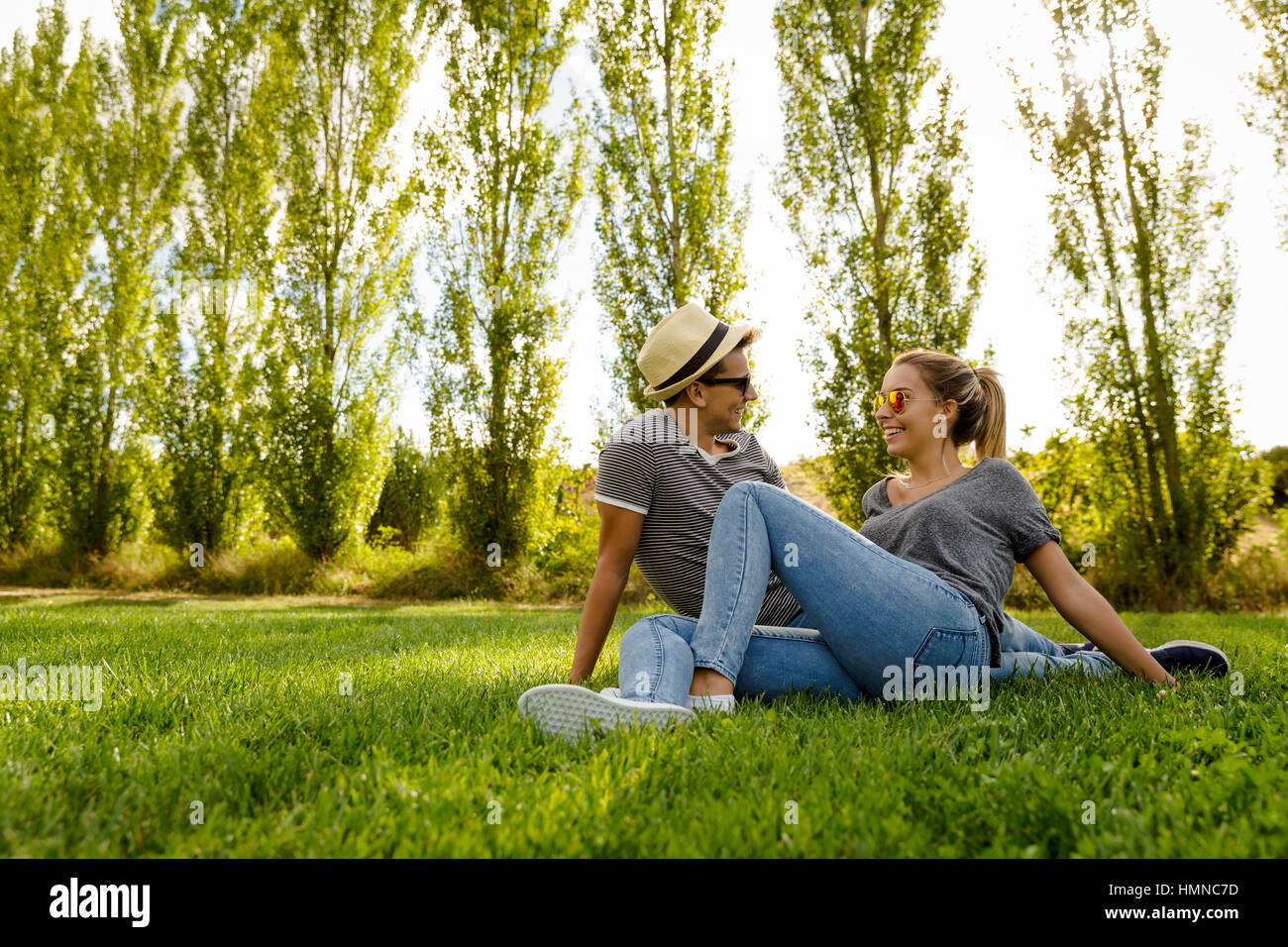 Portrait of a happy young couple enjoying a day in the park together ...