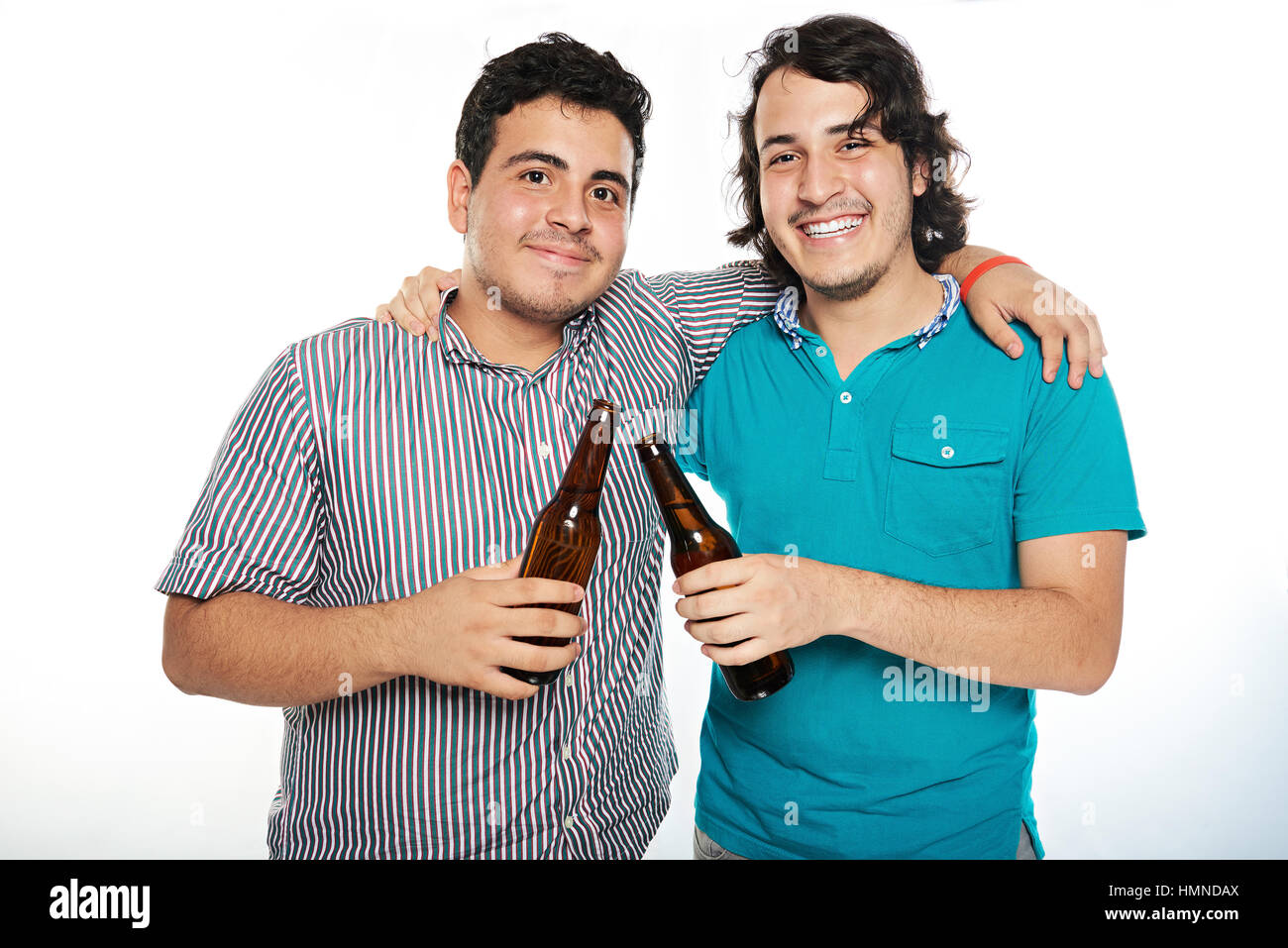 two smiling latino hispanic friend with beer isolated on white Stock Photo