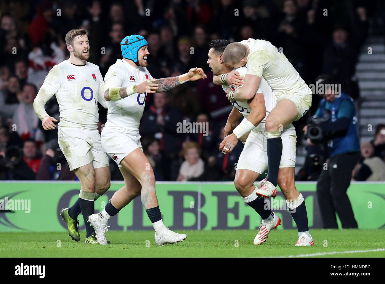 England's Ben Te'o (2nd right) celebrates scoring a try with team-mate Mike Brown during the RBS 6 Nations match at Twickenham Stadium, London. Stock Photo