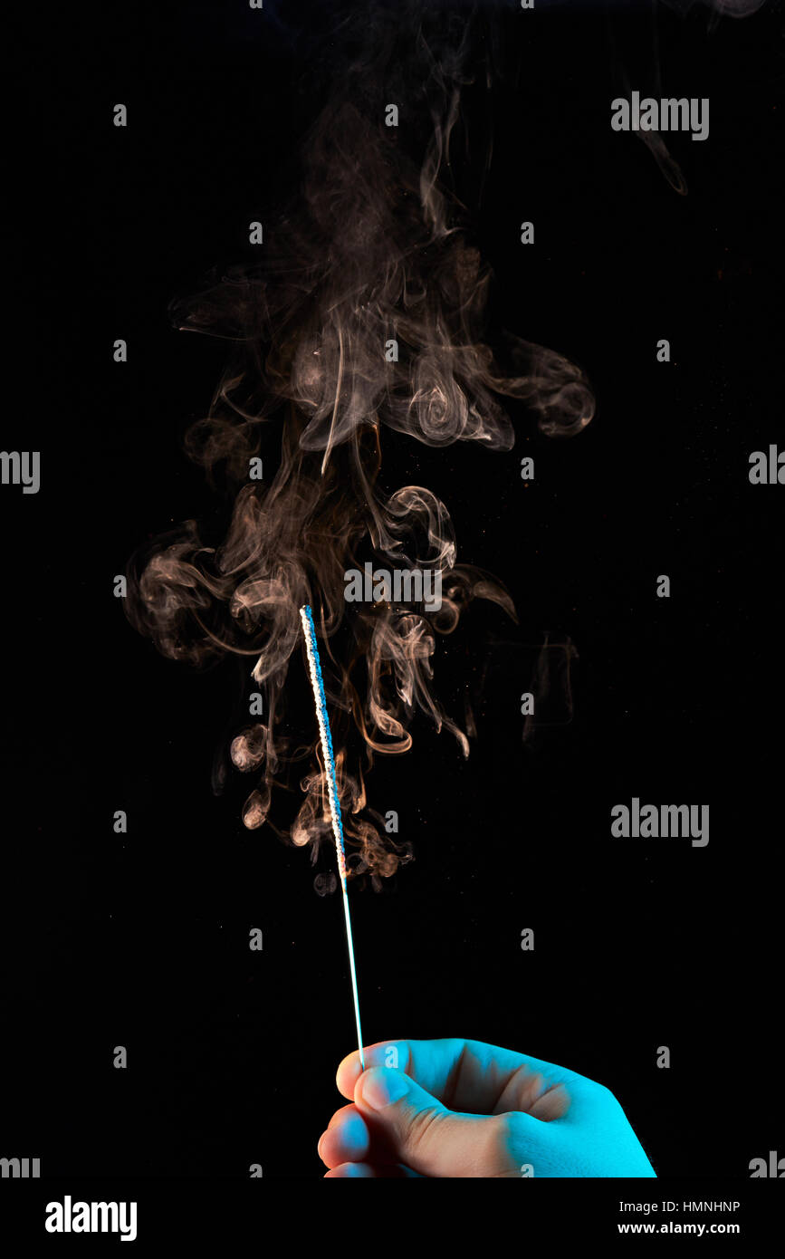 orange smoke after burn sparkler in hand Stock Photo Alamy