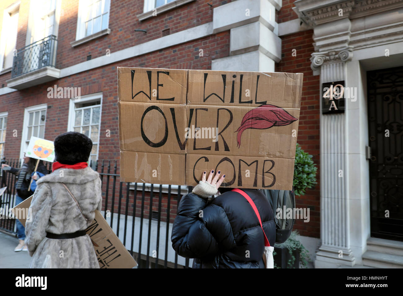 Protesters with anti Donald Trump comb over poster  'We Will Over Comb'  on the Women's March on London UK  21 January 2017   KATHY DEWITT Stock Photo