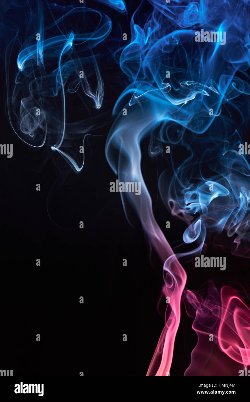 Blue and red colored smoke cloud on black background Stock Photo